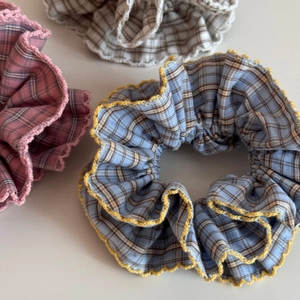 Detail showing high-quality plaid scrunchies with delicate embroidered edge finish