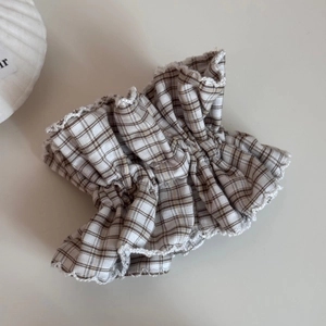 Close-up of brown plaid scrunchie with delicate white lace edges and ruffled texture