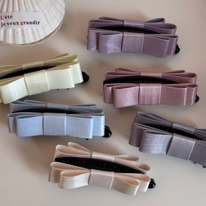 Group display of high-density satin bow banana clips in multiple soft pastel colors