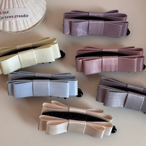 Elegant multi-layered satin bow banana hair clips in assorted pastel colors for women