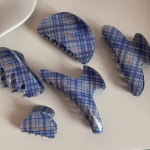 Detailed set of blue checkered hair claw clips in various sizes for diverse styling