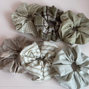 Vue détaillée de six chouchous en tissu à carreaux verts avec étiquette fait main