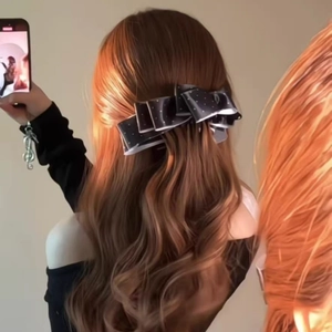 Polka dot satin bow hair clip accessory shown on brunette long wavy hair from behind