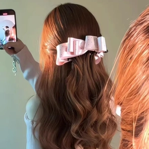 Pink satin polka dot bow hair clip for high ponytails and back of head styling