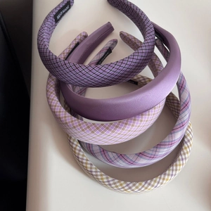 Set of five purple fabric scrunchies with hand-made labels in various patterns