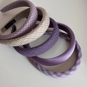 Close-up of handmade purple fabric scrunchie set with premium texture and woven labels