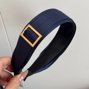 Elegant navy blue wide headband with textured fabric and gold metal side detail