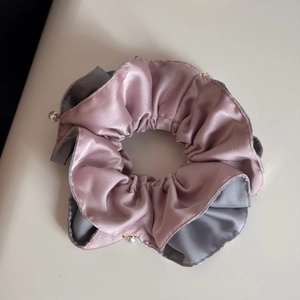 Detail of satin scrunchie with pink and grey patchwork fabric and white pearl trim