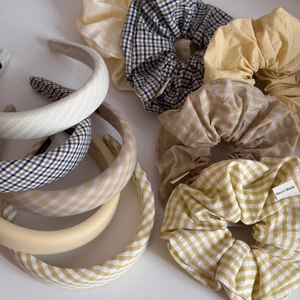 Schicke Satin-Plaid-Scrunchies und dicke Stirnbänder mit gelbem und blauem Karomuster