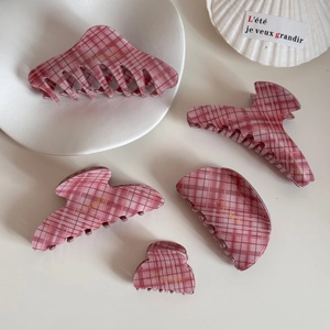 Pink checkered resin hair claws in various shapes including crescent and rectangle set
