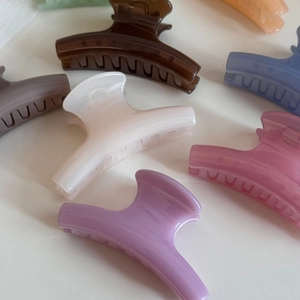 Detailed close-up of high-gloss resin hair claws in assorted matte candy colors