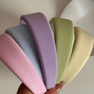 Set of colorful wide knitted sponge headbands in macaron colors with vertical stripe texture