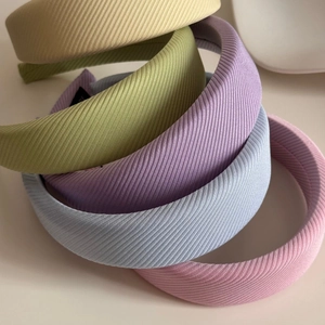 Detail of padded macaron headbands showing five colors and twill fabric texture