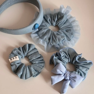 Detail of light blue polka dot hair set featuring a sponge headband and lace scrunchies