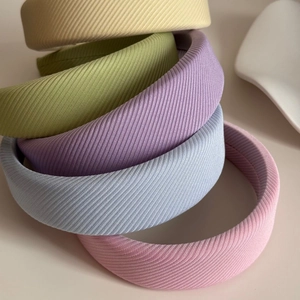 Macro detail of 5-pack macaron sponge headbands with textured ribbed fabric finish