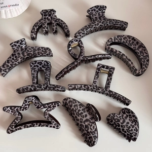Detailed set of 9 leopard print hair claws in cool grey and black acrylic finish