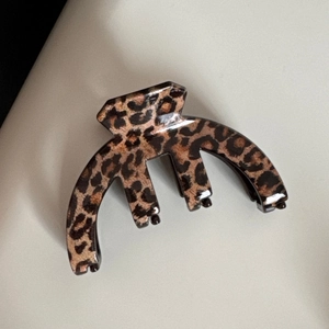Vue détaillée de la pince à cheveux motif léopard marron avec dents courbées solides