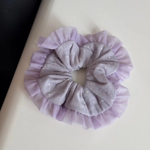 Detail of light purple polka dot scrunchie with semi-transparent lace mesh edges