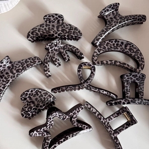 Collection of grey leopard print hair claws in various shapes for elegant hair styling