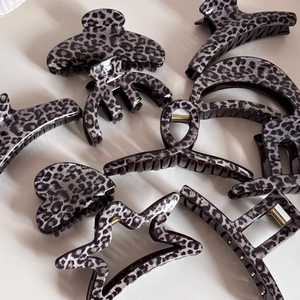 Leopard print hair claw clips in various shapes like star heart and rectangle patterns