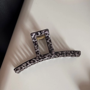 Close-up of leopard print hair claw clip with a strong gold metal spring mechanism