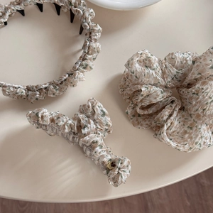 Floral hair accessories set with headband, scrunchie and heart claw clip on desk