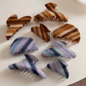 Detail view of 8-piece vintage hair claw set with brown and purple twill patterns