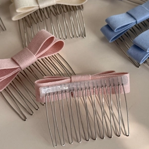 Detail view of colorful bow hair combs showing both front design and back structure