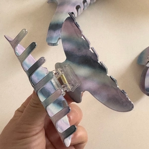 Detail of butterfly hair claw clip with blue and purple gradient watercolor texture finish