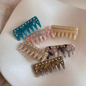 Detailed view of six vintage acetate hair combs with elegant rhinestone-encrusted edges