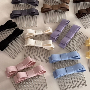 Flat lay view of assorted colorful fabric bow hair side combs with metal teeth on beige surface