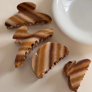 Set of four vintage brown and cream striped acetate hair claws in various elegant shapes
