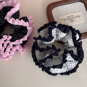 Close-up of pleated polka dot lace scrunchies with elegant ruffled edges in chiffon