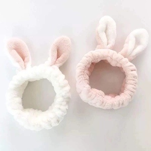 Cute plush rabbit ear headbands in pink and white for facial cleansing and skincare rituals