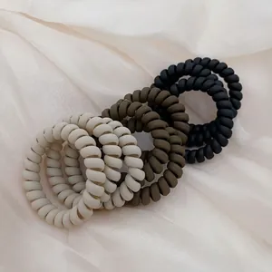 Morandi matte spiral telephone cord hair ties in cream white, olive green, and matte black