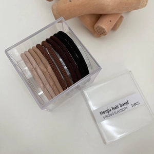 Detail showing 10pcs high-elastic hair ties in earth tones with a clear storage box