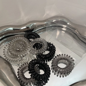 Minimalist gradient spiral hair ties in black and clear colors with storage box
