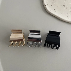 Three-piece set of mini metal hair claw clips in gold, silver, and black finishes