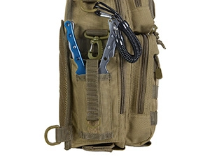 Detailed side view of khaki canvas fishing bag showing MOLLE system with tools and bungee cords