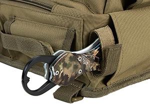 Detail of tan fishing bag with Molle system and camouflage fishing tool attachment