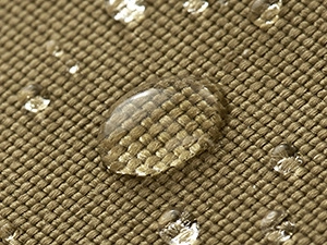 Detail showing waterproof heavy-duty canvas fabric with water droplets on the fishing bag