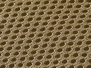 Detailed macro view of breathable olive brown honeycomb mesh fabric for fishing tackle bag