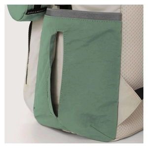 Detail view of water-resistant quilted baby diaper bag featuring side pocket and brand tag