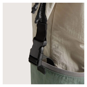 Detail view of durable plastic buckle and nylon webbing on quilted waterproof diaper backpack