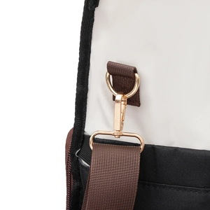 Detail of golden metal hook and D-ring on a canvas lunch bag with nylon shoulder strap