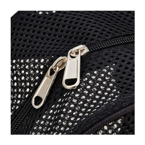 Detail of high-density black mesh fabric and smooth double metal zippers on the backpack