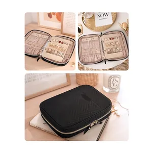Quilted black travel jewelry organizer case with multiple compartments and secure zipper