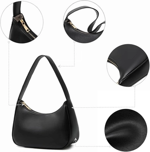 Macro detail of high-quality lychee grain leather and golden metal zipper on black handbag