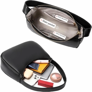 Detail view of black crescent bag interior showing zip pocket and daily storage capacity