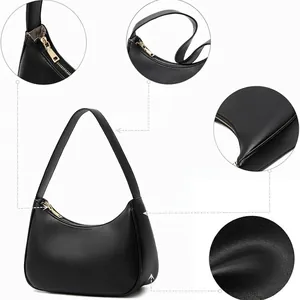 Minimalist black matte leather crescent hobo bag with gold zipper and shoulder strap